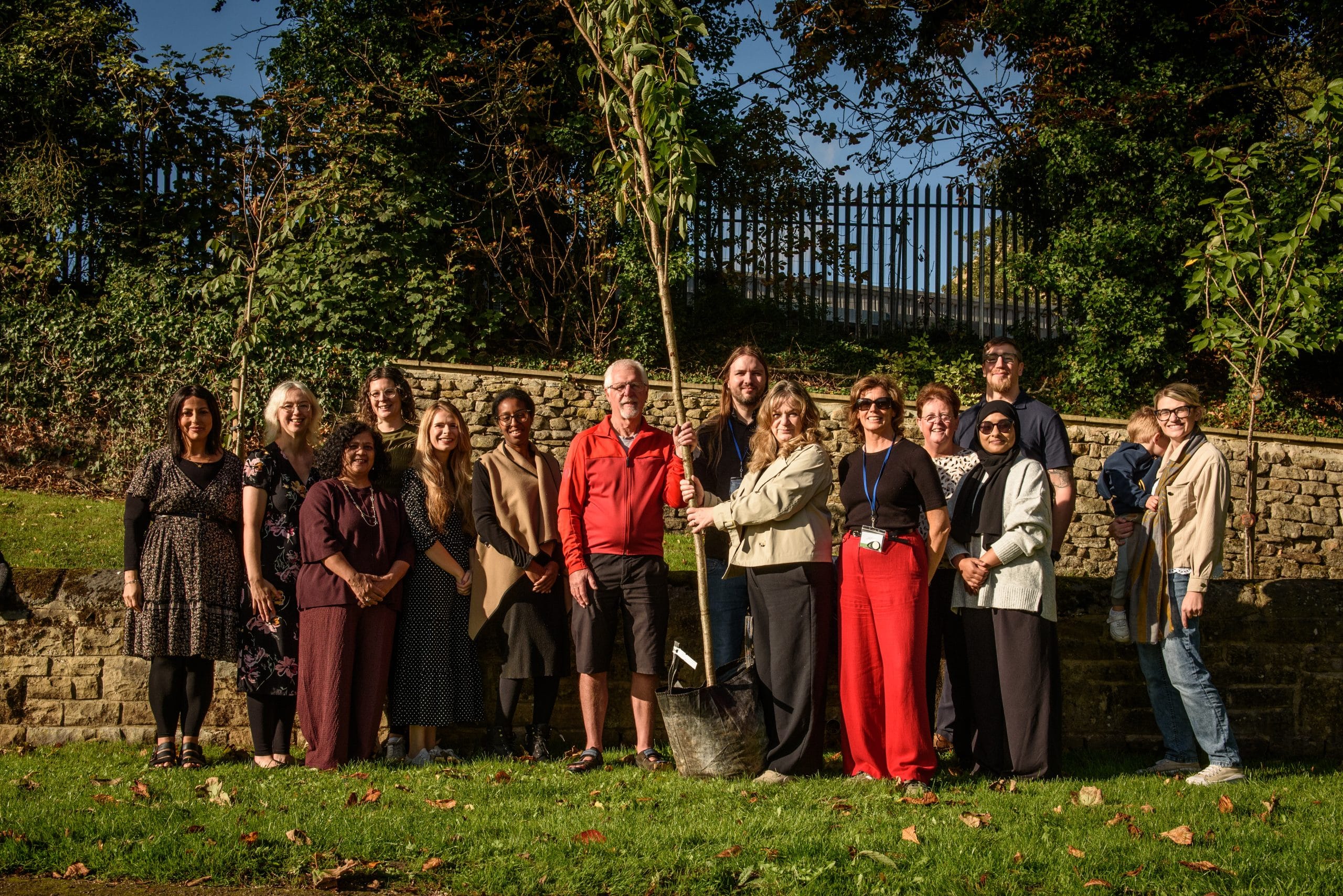 A group of people planting the commemorative tree